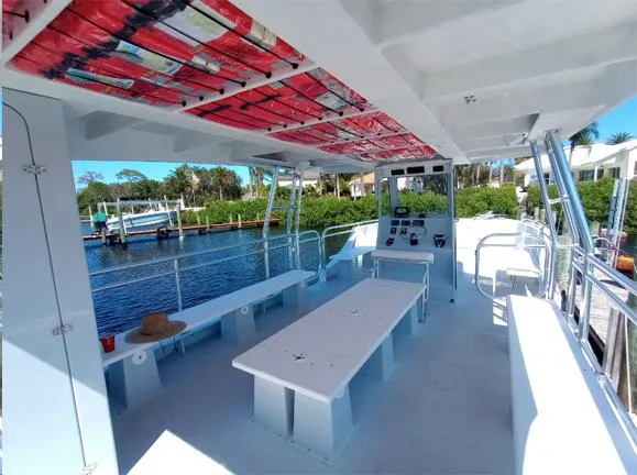 Slide: The Image of Spacious deck of a 2025 Custom 34 boat with seating and control panel. - 6
