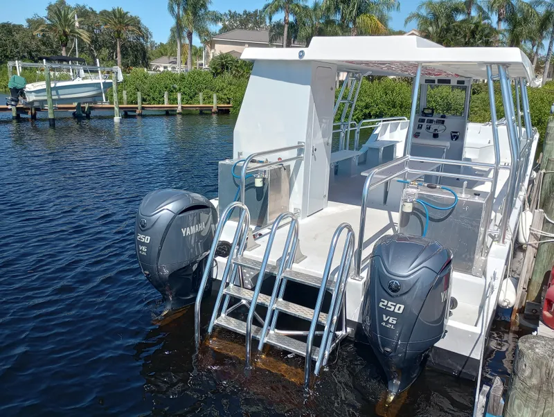 Slide: The Image of Custom 34 boat, 2025 model, with dual Yamaha 250 V6 engines docked by the water. - 7