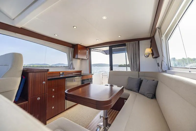 Slide: The Image of Luxurious interior of 2025 Nimbus 405 Flybridge yacht with elegant seating and panoramic windows. - 14