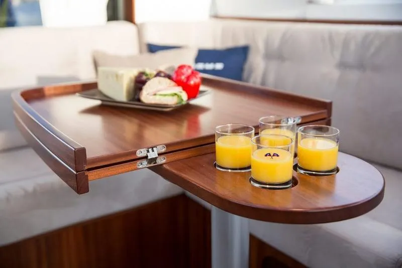 Slide: The Image of Luxurious interior of 2025 Nimbus 405 Flybridge with wooden table and refreshments. - 15