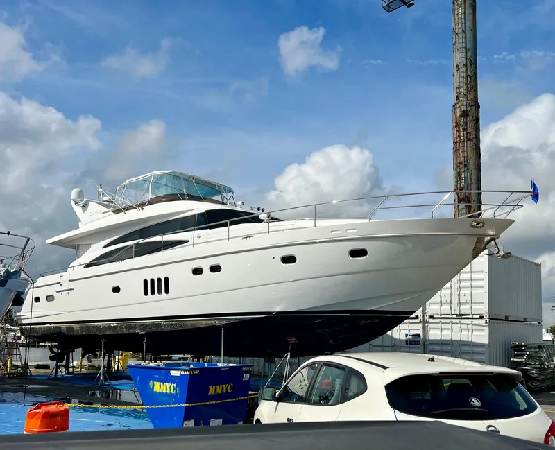 Slide: The Image of 2008 Viking Sport Cruisers 70 Motor Yacht on dry dock under a cloudy sky. - 0