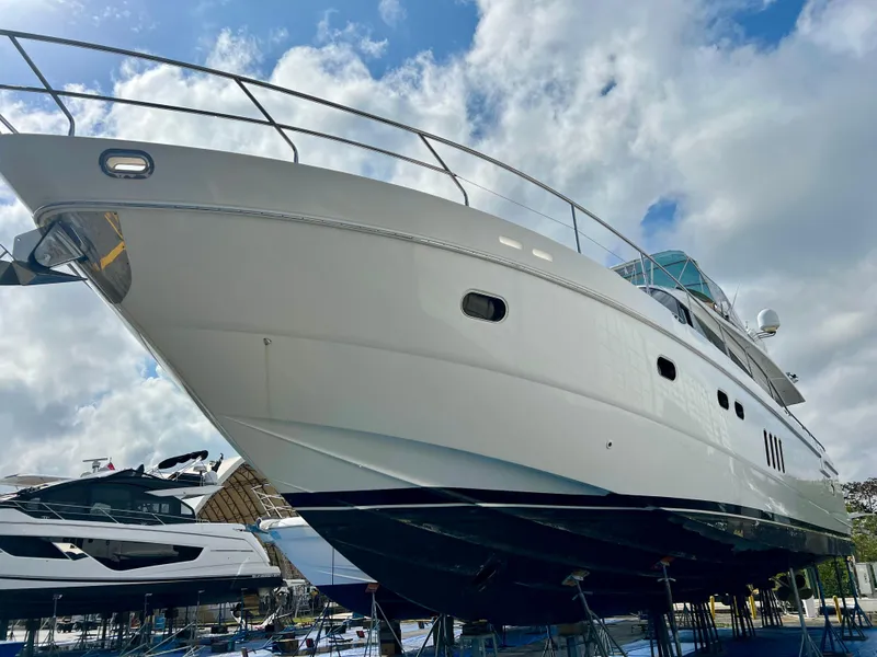 Slide: The Image of 2008 Viking Sport Cruisers 70 Motor Yacht on display under a cloudy sky. - 1