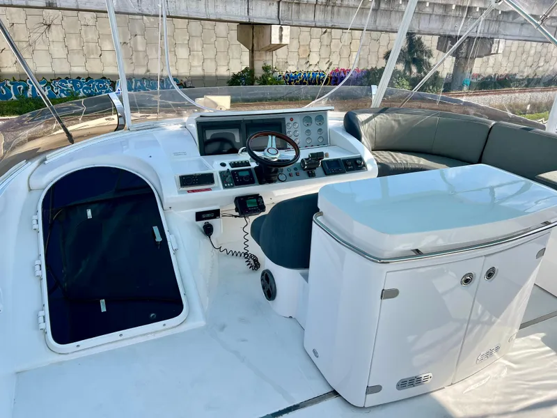 Slide: The Image of 2008 Viking Sport Cruisers 70 Motor Yacht helm with modern controls and seating. - 10