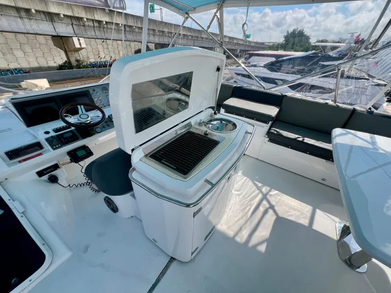 Slide: The Image of 2008 Viking Sport Cruisers 70 Motor Yacht interior with helm, grill, and seating area. - 11