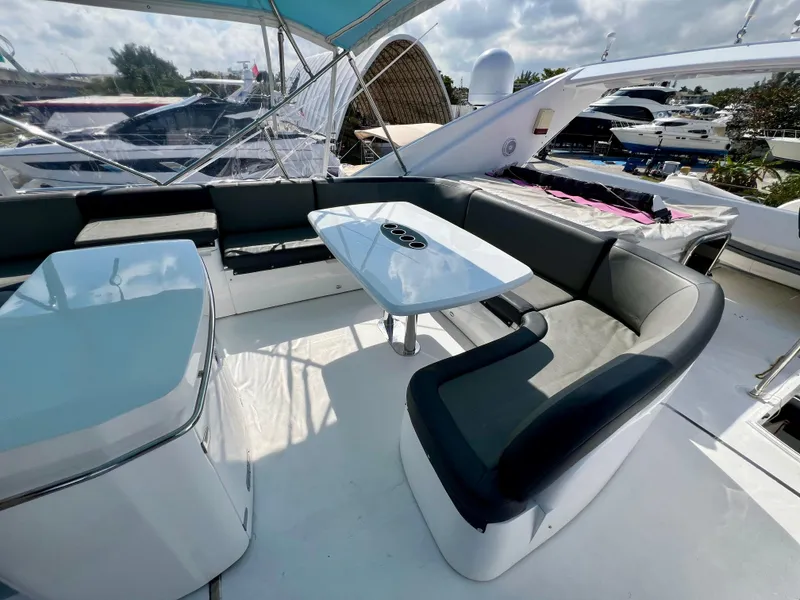 Slide: The Image of 2008 Viking Sport Cruisers 70 Motor Yacht, featuring a sleek outdoor seating area with modern tables. - 12