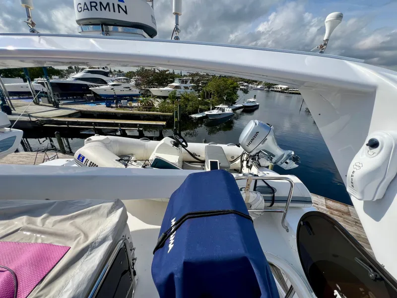 Slide: The Image of 2008 Viking Sport Cruisers 70 Motor Yacht docked, featuring Garmin equipment and scenic marina view. - 13
