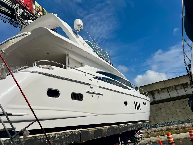 Slide: The Image of 2008 Viking Sport Cruisers 70 Motor Yacht on dry dock under blue sky. - 2