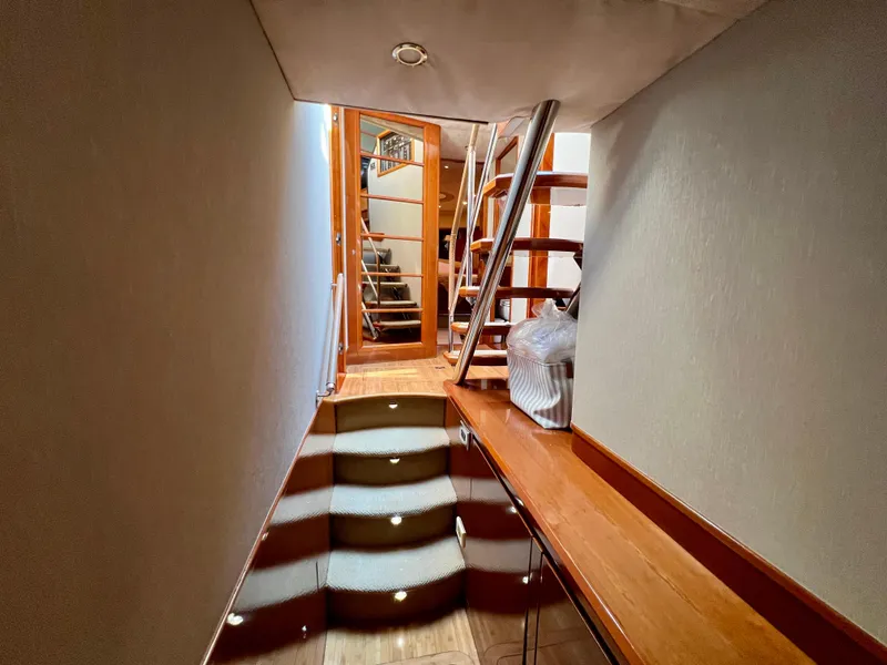 Slide: The Image of Interior hallway of 2008 Viking Sport Cruisers 70 Motor Yacht with wooden stairs and modern design. - 22