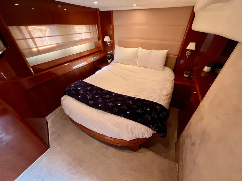 Slide: The Image of Luxurious bedroom in 2008 Viking Sport Cruisers 70 Motor Yacht with elegant wood finishes. - 26