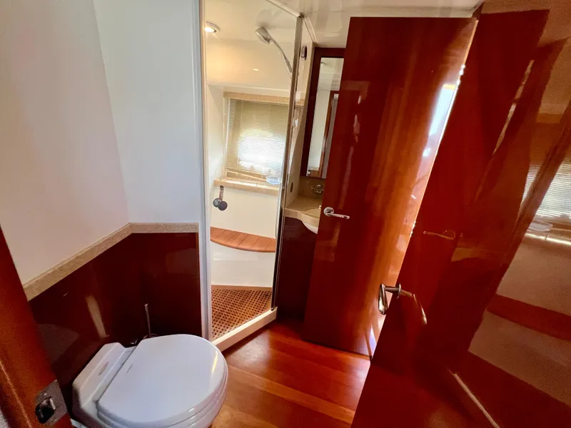 Slide: The Image of Luxurious bathroom in 2008 Viking Sport Cruisers 70 Motor Yacht with wooden finishes and modern fixtures. - 28