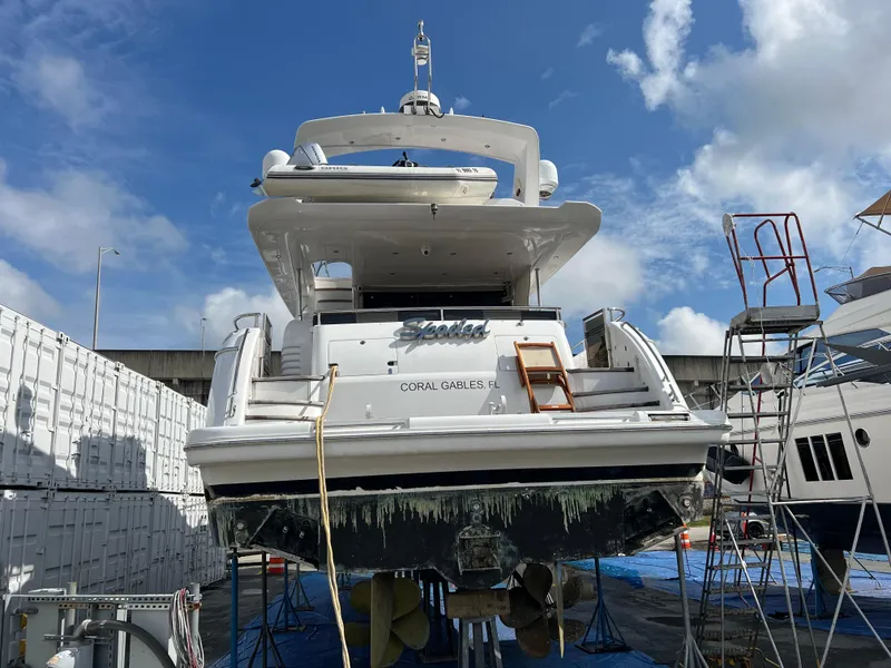 Slide: The Image of 2008 Viking Sport Cruisers 70 Motor Yacht in dry dock, Coral Gables, clear sky. - 3