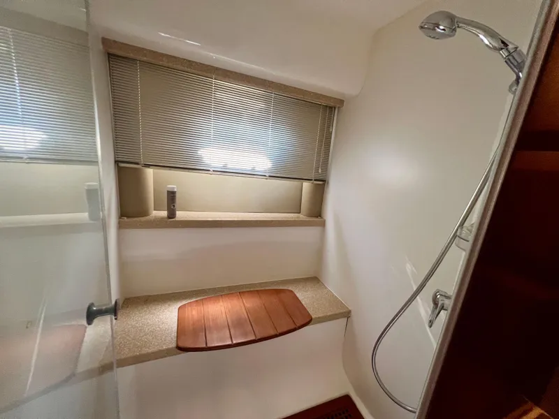 Slide: The Image of Shower area in 2008 Viking Sport Cruisers 70 Motor Yacht with wooden bench and window blinds. - 30