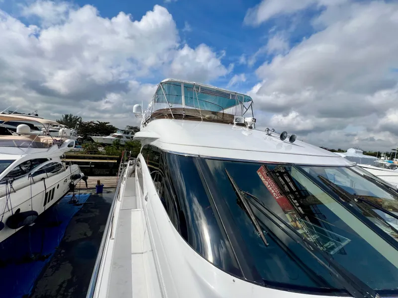 Slide: The Image of 2008 Viking Sport Cruisers 70 Motor Yacht docked under a partly cloudy sky. - 6
