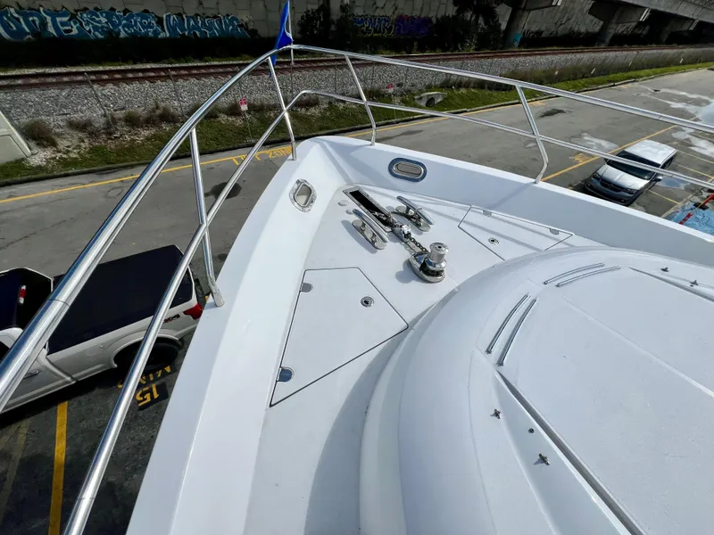 Slide: The Image of Bow view of 2008 Viking Sport Cruisers 70 Motor Yacht, docked near railway tracks. - 8