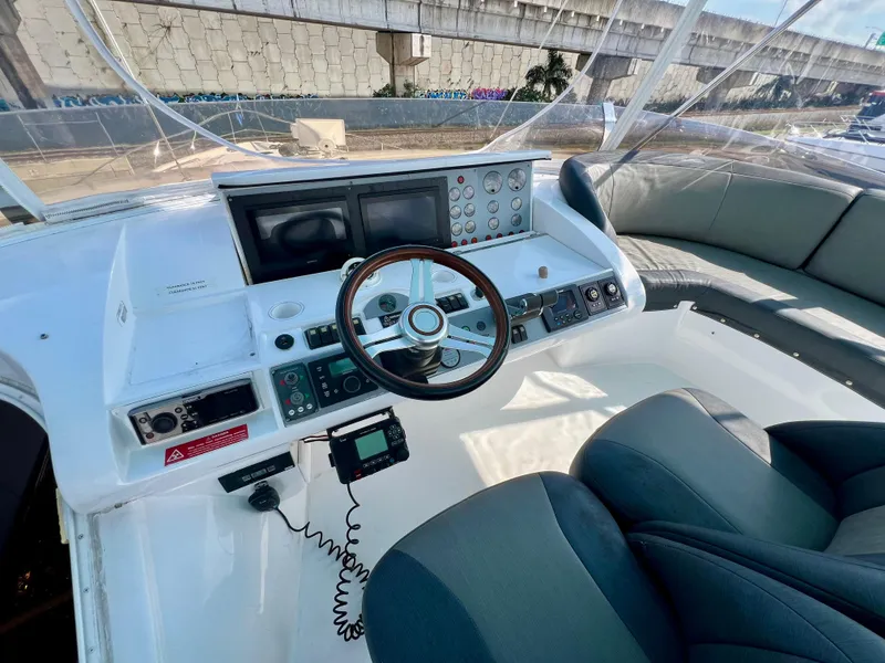 Slide: The Image of Cockpit of 2008 Viking Sport Cruisers 70 Motor Yacht with steering wheel and navigation controls. - 9