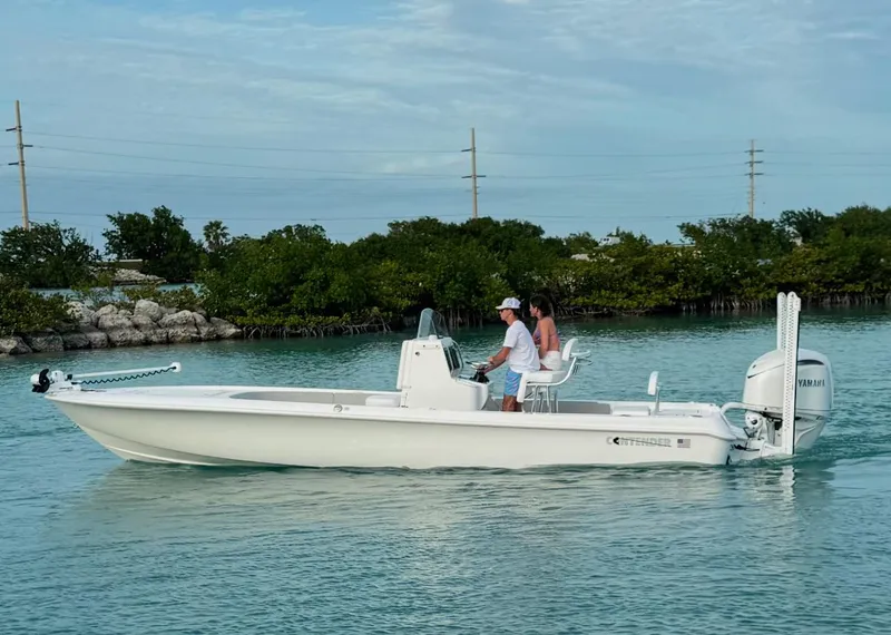 The Image of 2025 Contender 26 Bay boat on clear turquoise water under blue sky. - 0