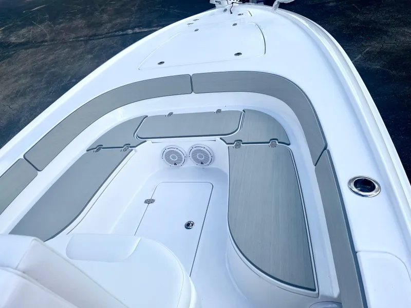 Slide: The Image of 2025 Contender 26 Bay boat interior with seating and console, viewed from the bow. - 9