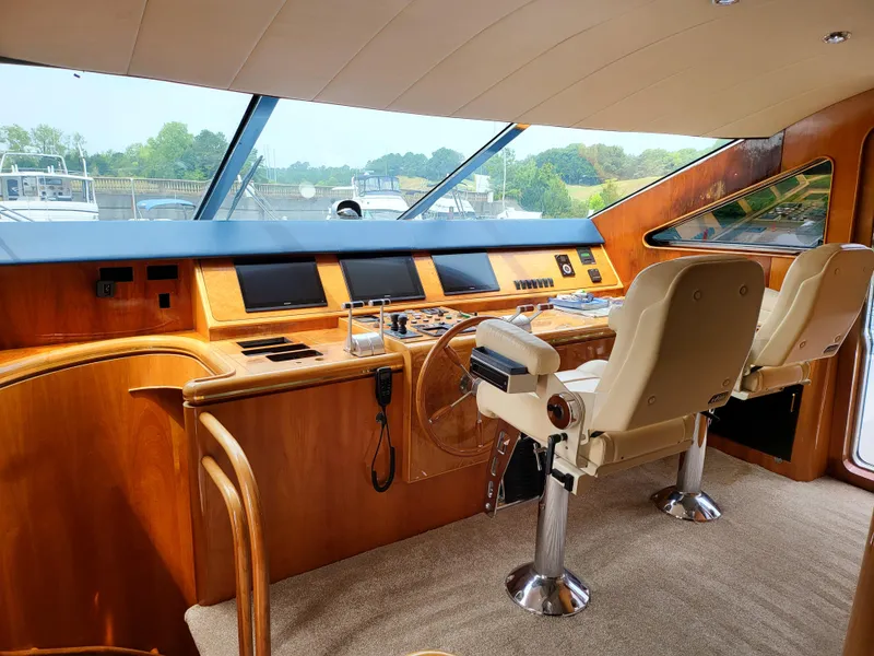 Slide: The Image of Interior helm of 2000 Horizon 74 Motor Yacht with dual captain chairs and navigation controls. - 10