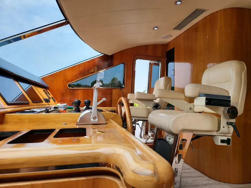 Slide: The Image of Interior helm of 2000 Horizon 74 Motor Yacht with wooden dashboard and leather seats. - 11