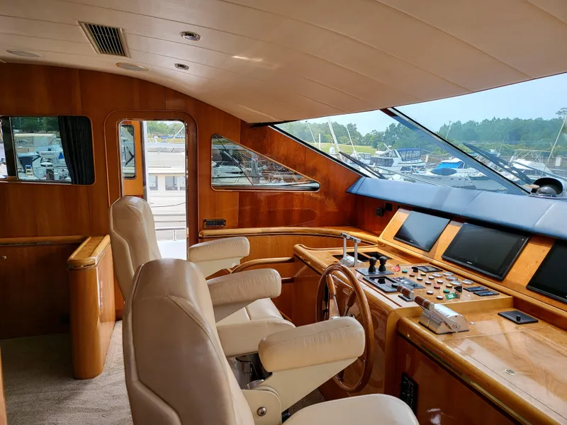 Slide: The Image of Interior of 2000 Horizon 74 Motor Yacht with helm, leather seats, and control panels. - 13