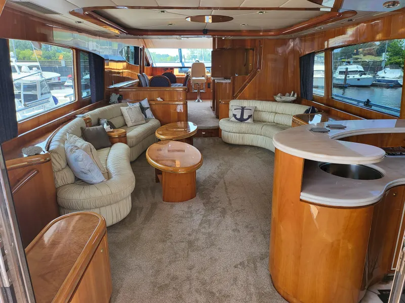 Slide: The Image of Luxurious interior of a 2000 Horizon 74 Motor Yacht with plush seating and wooden finishes. - 15