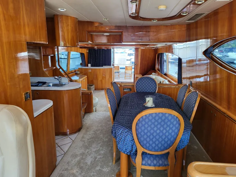 Slide: The Image of Interior of 2000 Horizon 74 Motor Yacht with elegant wood finish and dining area. - 19