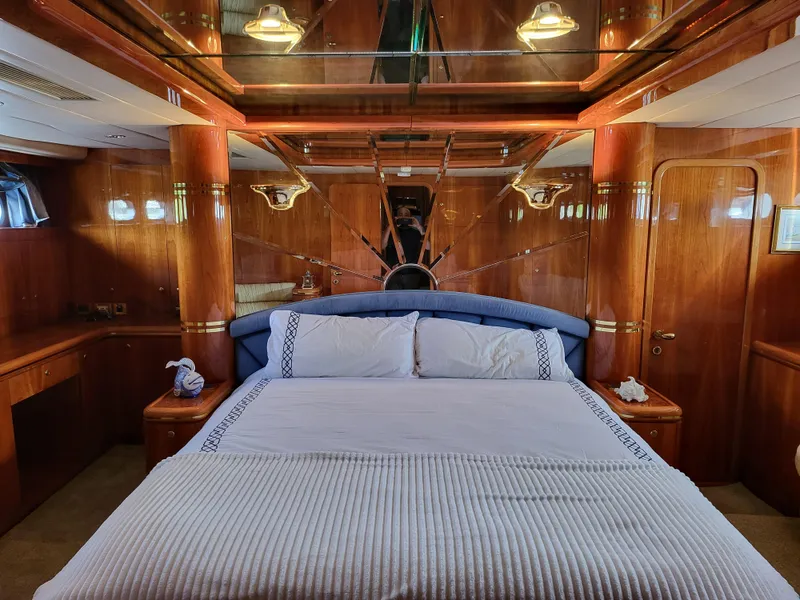 Slide: The Image of Luxurious bedroom interior of a 2000 Horizon 74 Motor Yacht with elegant wood finishes. - 27