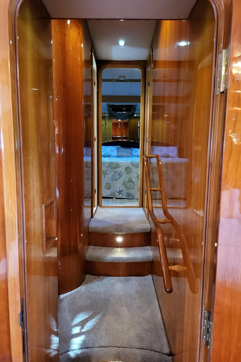 Slide: The Image of Interior hallway of 2000 Horizon 74 Motor Yacht with wooden finishes and carpeted steps. - 33