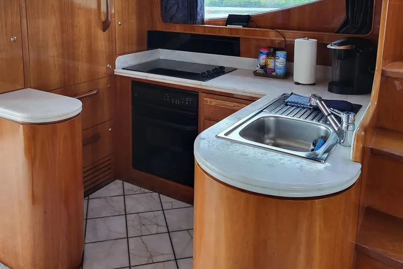 Slide: The Image of Kitchen area of 2000 Horizon 74 Motor Yacht with wood cabinetry and modern appliances. - 36