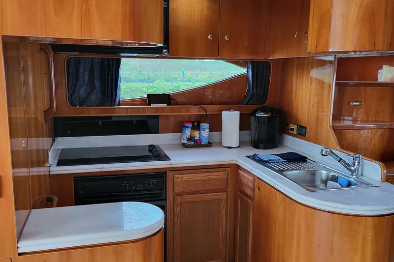 Slide: The Image of Interior of 2000 Horizon 74 Motor Yacht kitchen with wooden cabinetry and modern appliances. - 37