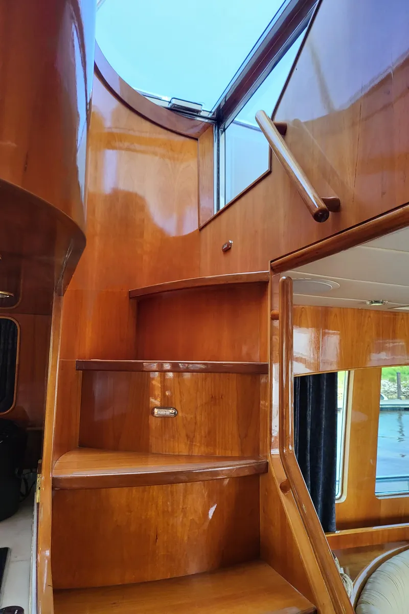 Slide: The Image of Interior wooden staircase of 2000 Horizon 74 Motor Yacht, featuring polished finish and natural light. - 39