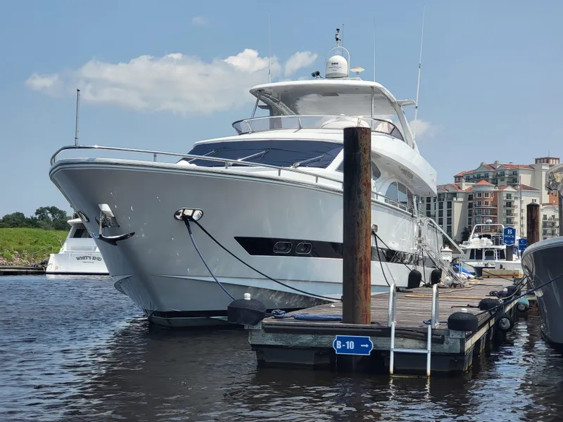 Slide: The Image of Horizon 74 Motor Yacht 2000 docked at marina, clear sky, waterfront buildings. - 4
