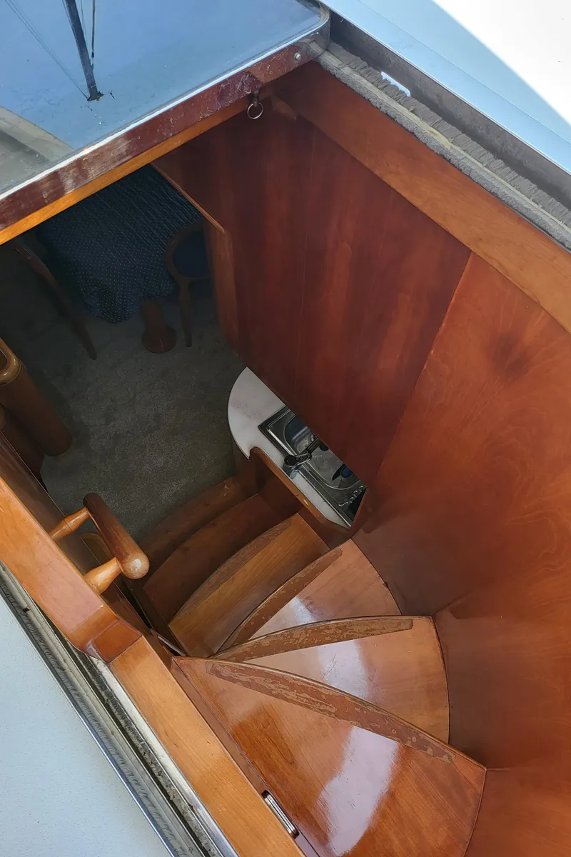 Slide: The Image of Interior view of 2000 Horizon 74 Motor Yacht with wooden staircase and cozy cabin area. - 42