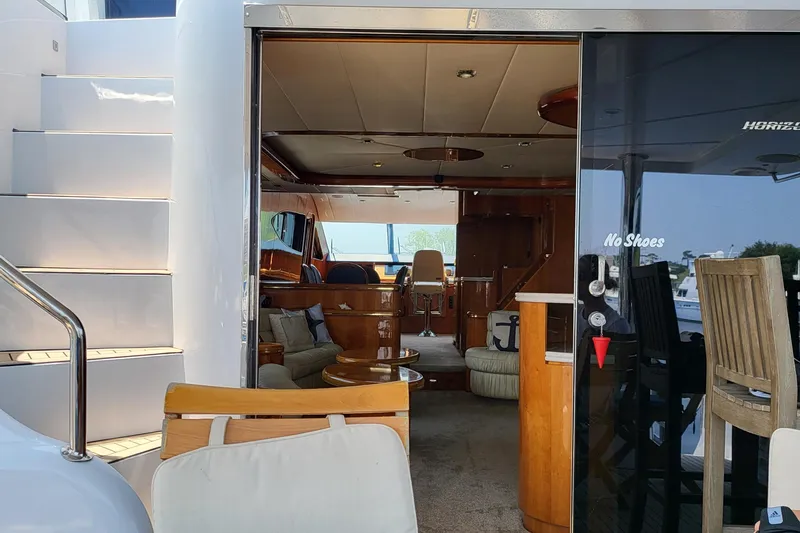Slide: The Image of Interior view of a 2000 Horizon 74 Motor Yacht, featuring elegant wooden furnishings. - 43