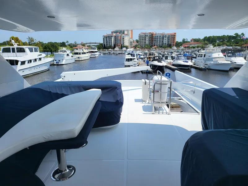 Slide: The Image of Horizon 74 Motor Yacht 2000, docked in a marina with multiple boats and waterfront buildings. - 7