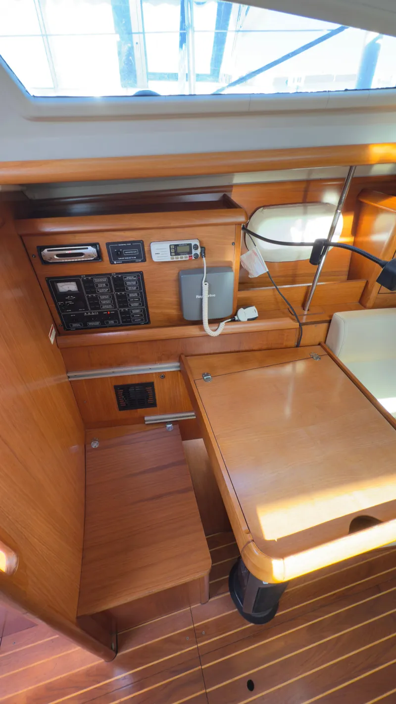 Slide: The Image of 2004 Jeanneau Sun Fast 35 interior with navigation station and wooden finish. - 12