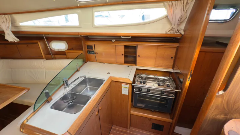 Slide: The Image of 2004 Jeanneau Sun Fast 35 yacht interior with kitchen, sink, and stove. - 14