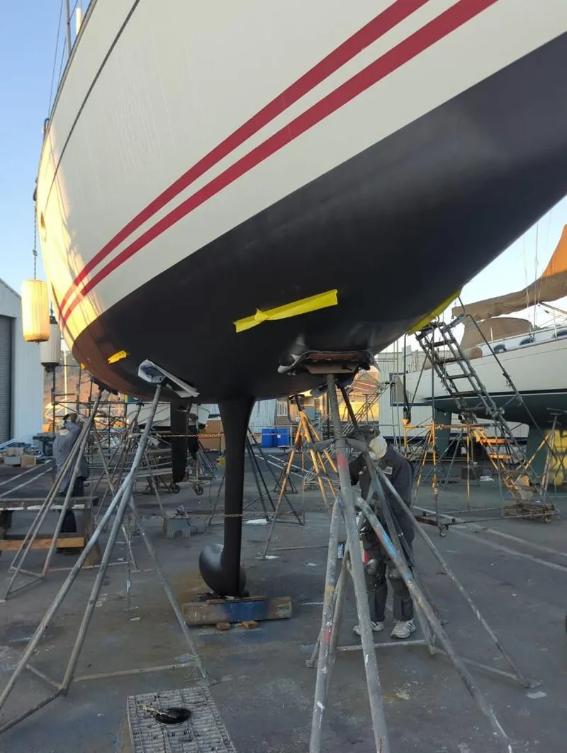 Slide: The Image of 2004 Jeanneau Sun Fast 35 sailboat in dry dock, undergoing maintenance. - 21