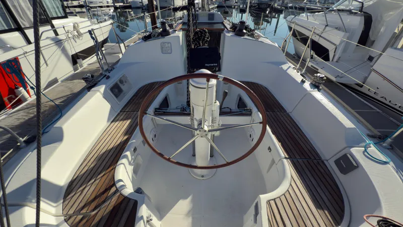 Slide: The Image of 2004 Jeanneau Sun Fast 35 sailboat cockpit with wooden deck and steering wheel. - 7