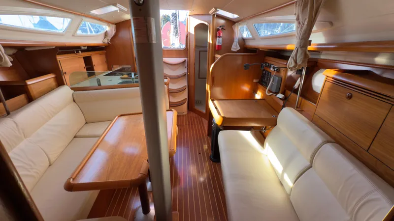 Slide: The Image of Interior of 2004 Jeanneau Sun Fast 35 sailboat, featuring wood finish and comfortable seating. - 9
