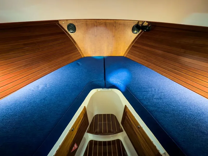 Slide: The Image of Hinckley Talaria 34 (2014) boat interior with fish-patterned seating and wooden table. - 16