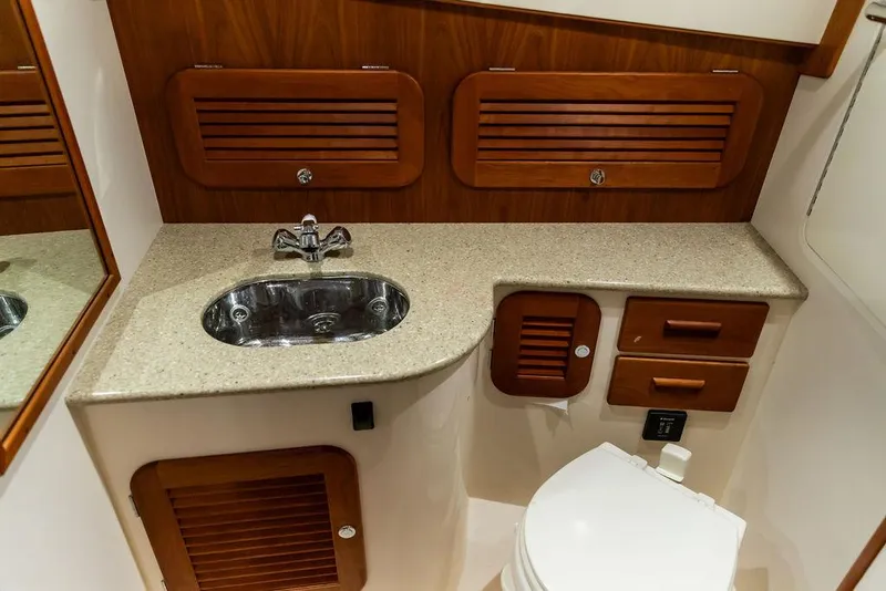 Slide: The Image of Luxurious 2014 Hinckley Talaria 34 yacht interior with fish-patterned seating and polished wooden table. - 17