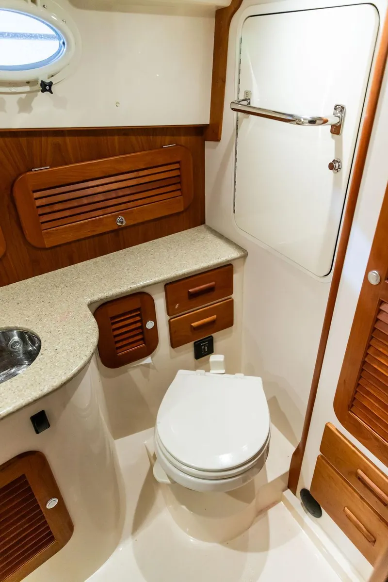 Slide: The Image of 2014 Hinckley Talaria 34 yacht kitchen with stove, sink, and microwave. - 18
