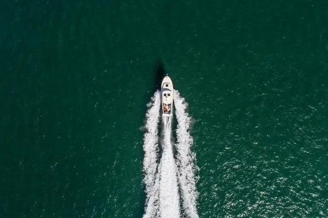 Slide: The Image of Aerial view of 2014 Hinckley Talaria 34 cruising on open water. - 2
