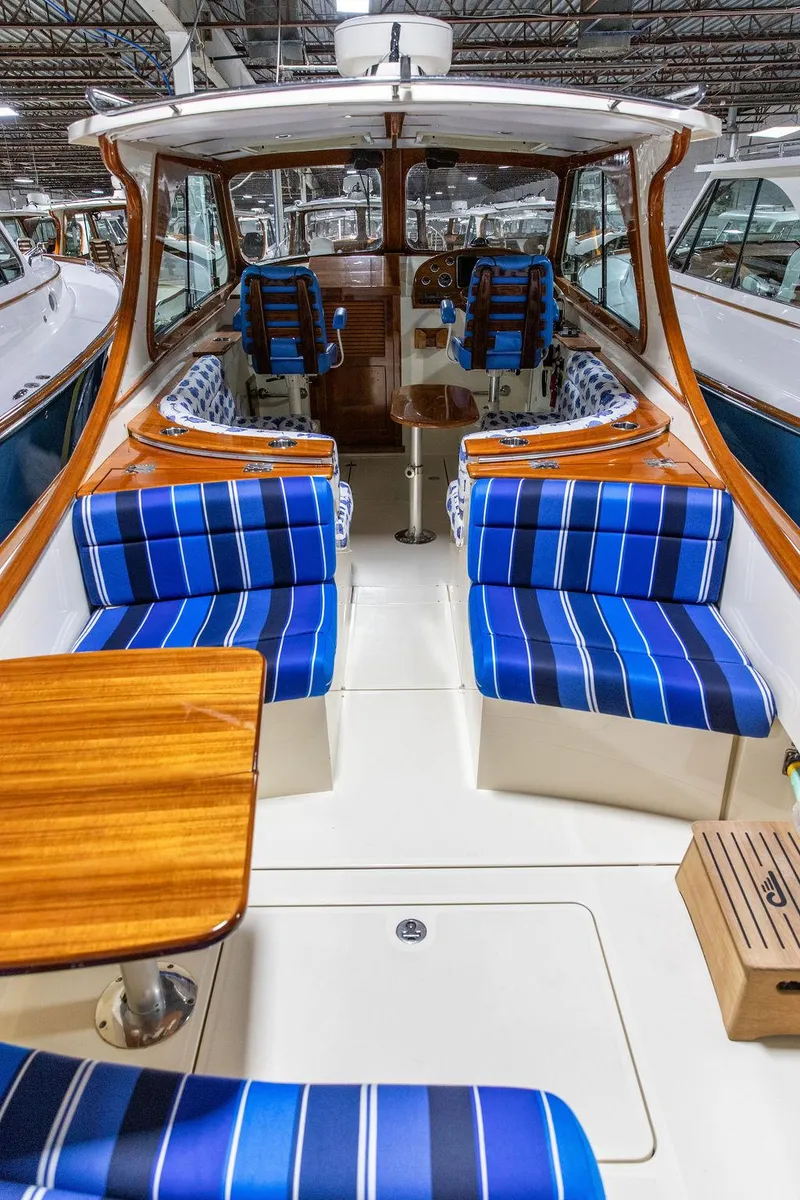 Slide: The Image of 2014 Hinckley Talaria 34 helm with wooden steering wheel and navigation display. - 3