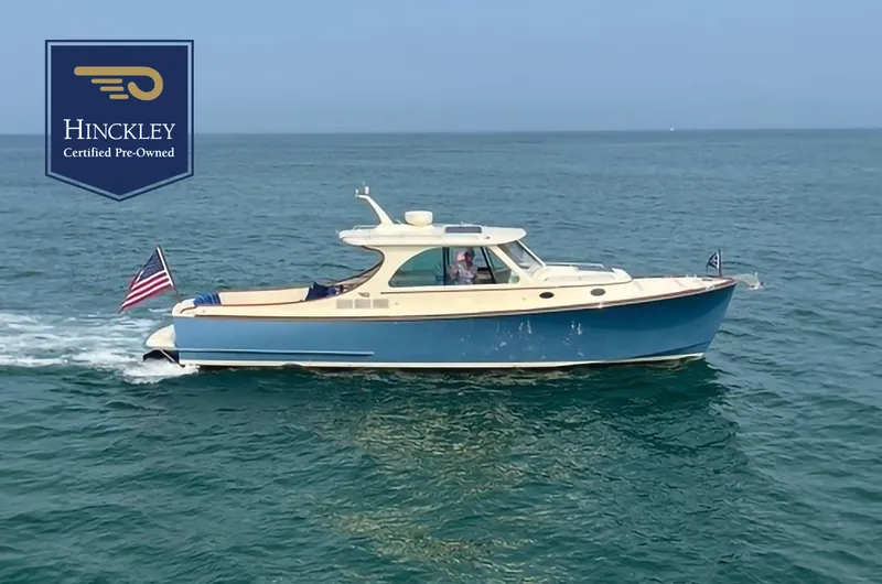 Slide: The Image of 2014 Hinckley Talaria 34 cruising on open water, certified pre-owned. - 0