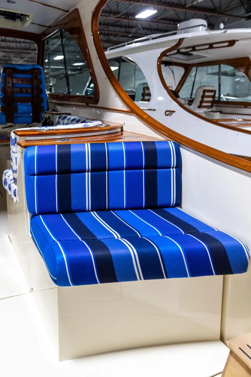 Slide: The Image of 2014 Hinckley Talaria 34 yacht interior with kitchenette, wooden cabinetry, and stainless steel sink. - 5