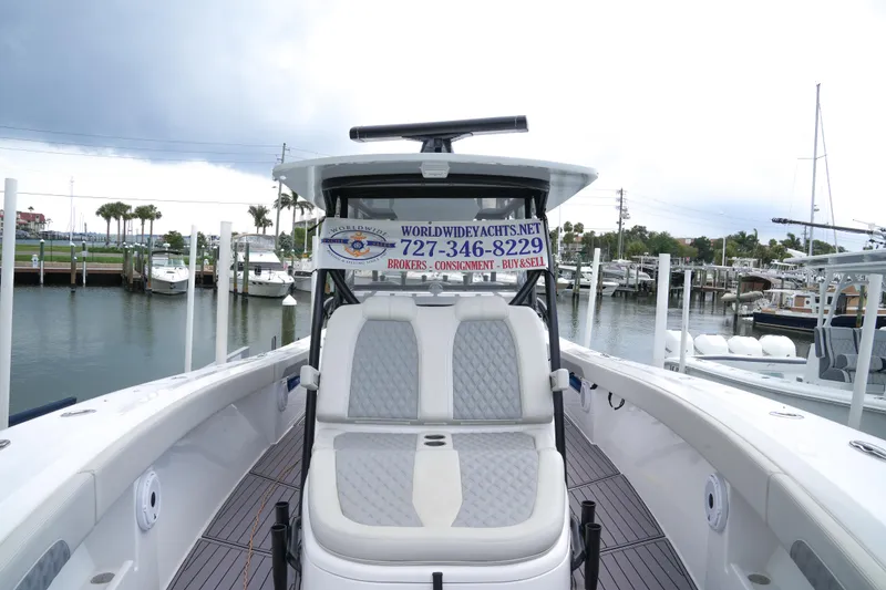 Slide: The Image of 2023 Front Runner 39 CC boat docked at marina, showcasing seating and helm. - 1