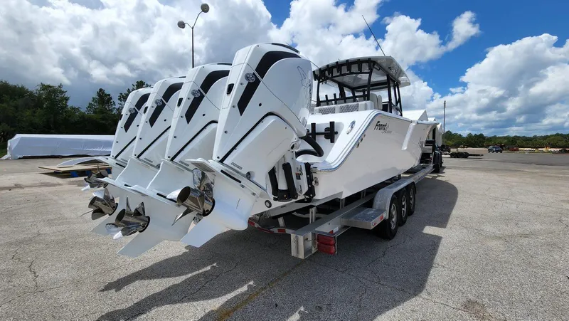 Slide: The Image of 2023 Front Runner 39 CC boat with triple engines on a trailer. - 12