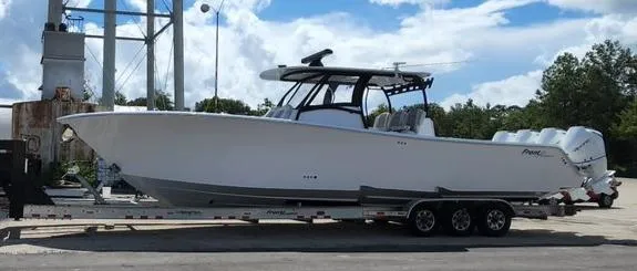 Slide: The Image of 2023 Front Runner 39 CC boat on trailer, parked outdoors. - 14